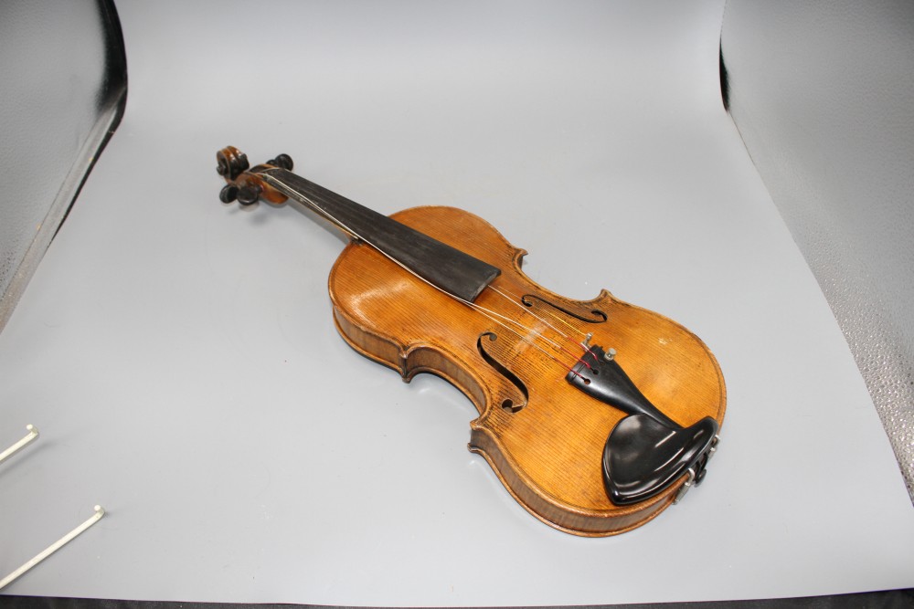 A violin with two piece back and bow, and a childs violin with bow, both with cases